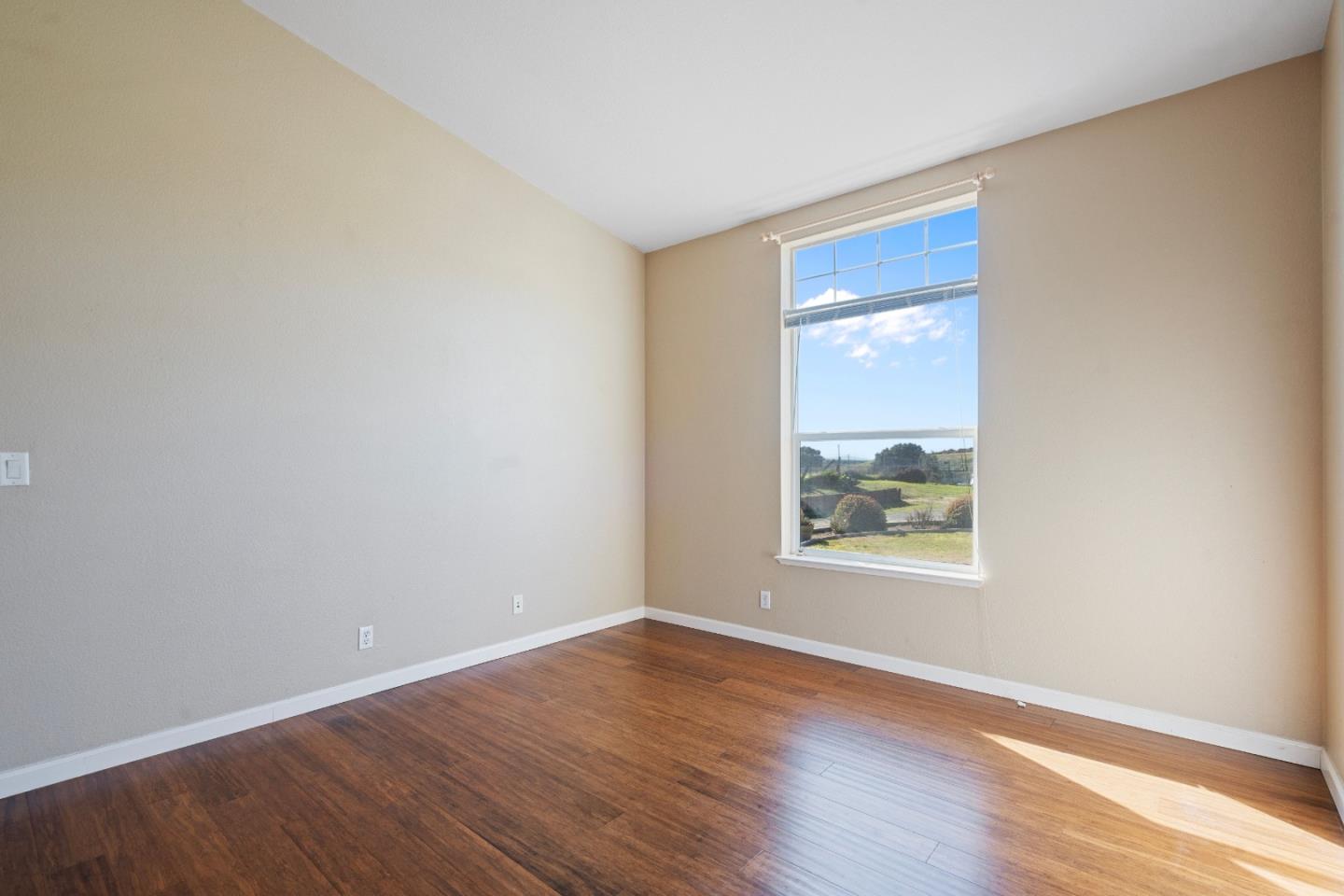 10114 Reese Circle Salinas, CA 93907 - Photo 11 of 43 a view of an empty room with wooden floor and a window