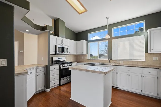 a kitchen with stainless steel appliances granite countertop a stove and a sink