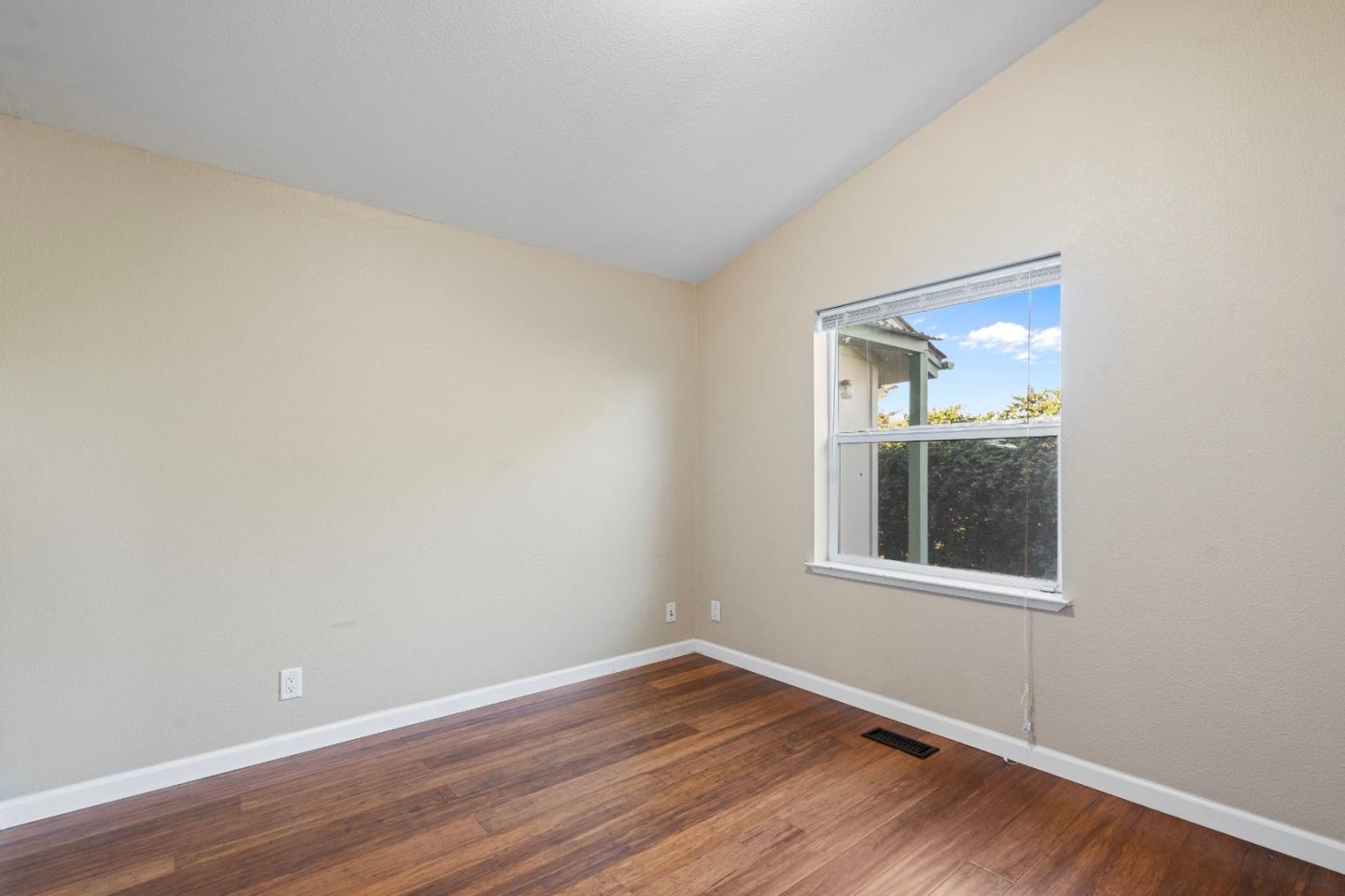 10114 Reese Circle Salinas, CA 93907 - Photo 24 of 43 a view of an empty room with wooden floor and a window
