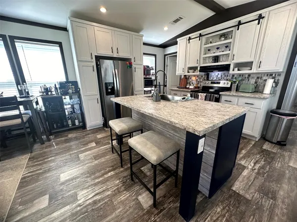 a kitchen with a stove and a refrigerator
