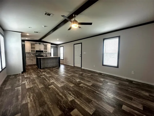 a kitchen with kitchen island granite countertop stainless steel appliances cabinets a sink and a counter top space