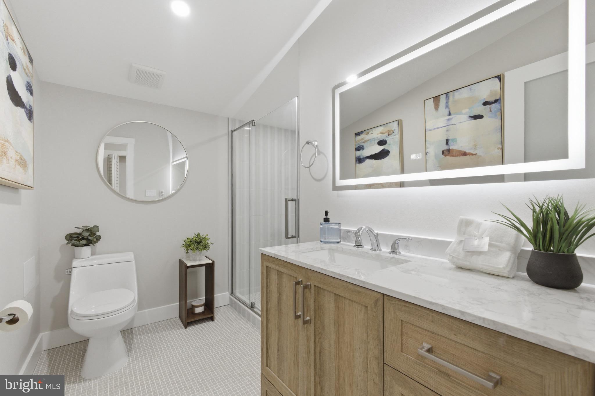 5218 Nick Road Shady Side, MD 20764 - Photo 14 of 24 a bath room with a toilet a sink and a mirror