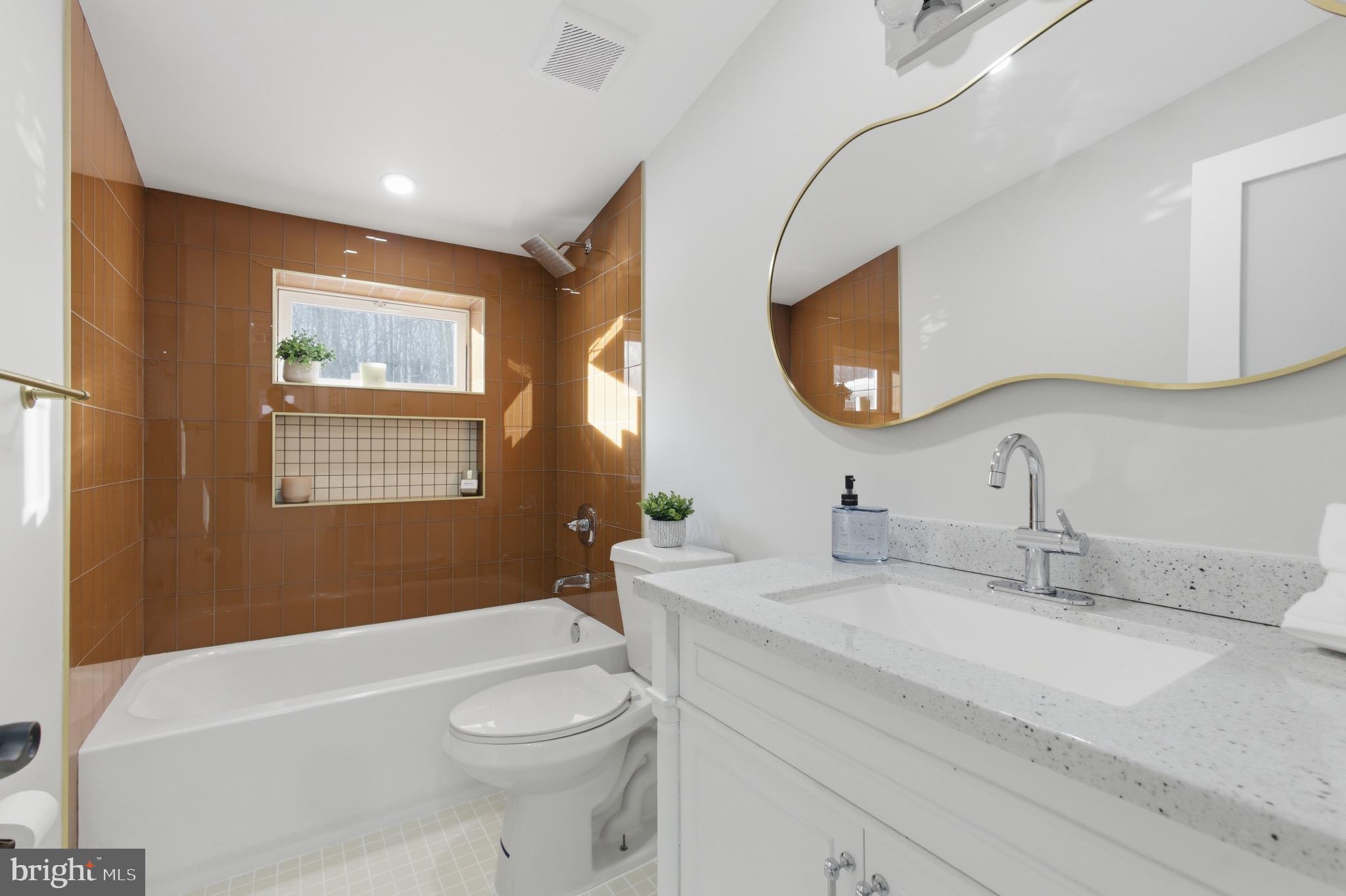 5218 Nick Road Shady Side, MD 20764 - Photo 19 of 24 a bathroom with a toilet a sink a mirror and a bathtub