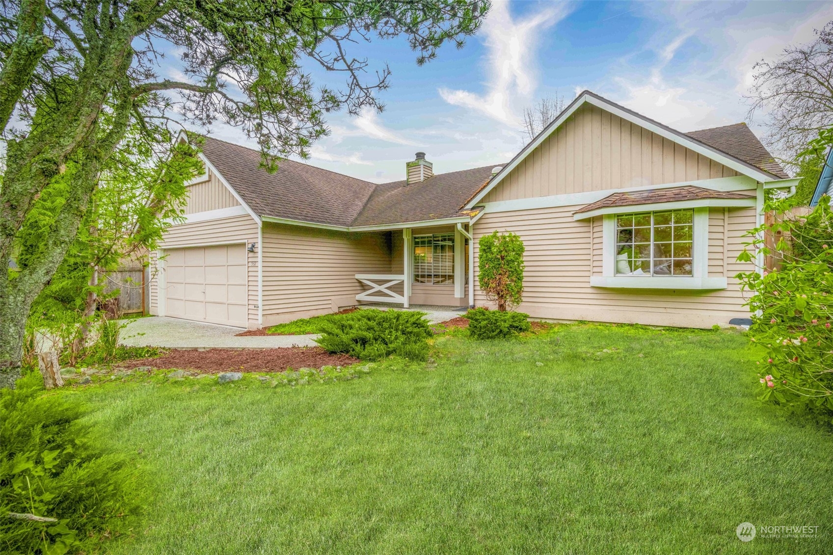 a front view of house with yard and green space