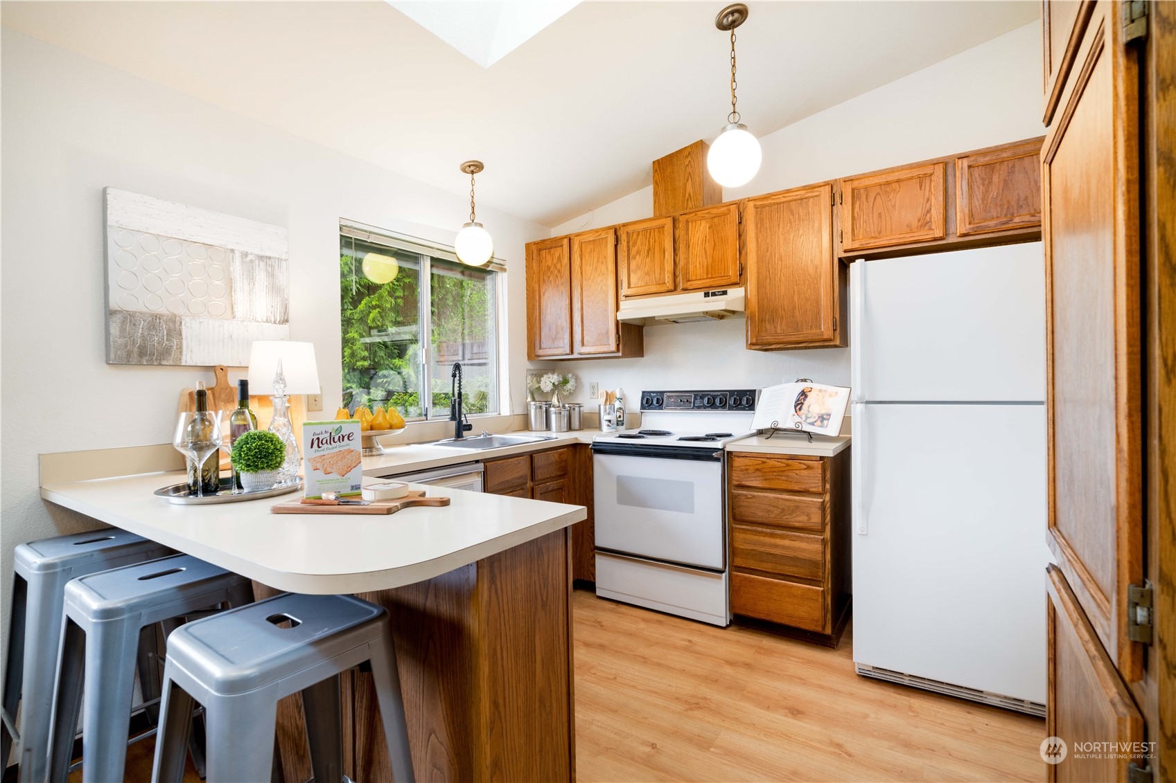 532 167th Street Southeast Bothell, WA 98012 - Photo 8 of 21 a kitchen with refrigerator cabinets and wooden floor