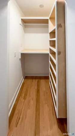 a view of walk in closet with empty racks