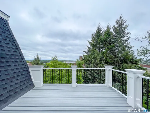 a view of a balcony with wooden floor