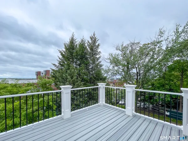 a view of a wooden deck with a yard