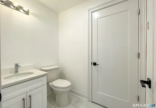 a bathroom with a toilet a sink and a shower