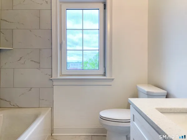 a bathroom with a sink a toilet and tub