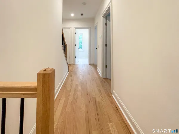 a view of hallway with wooden floor