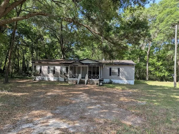 a house that has a tree in front of it