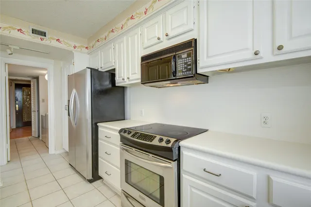 a spacious bathroom with a granite countertop sink mirror and cabinets