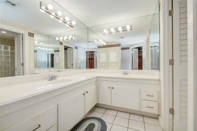 a bathroom with a sink vanity and a mirror