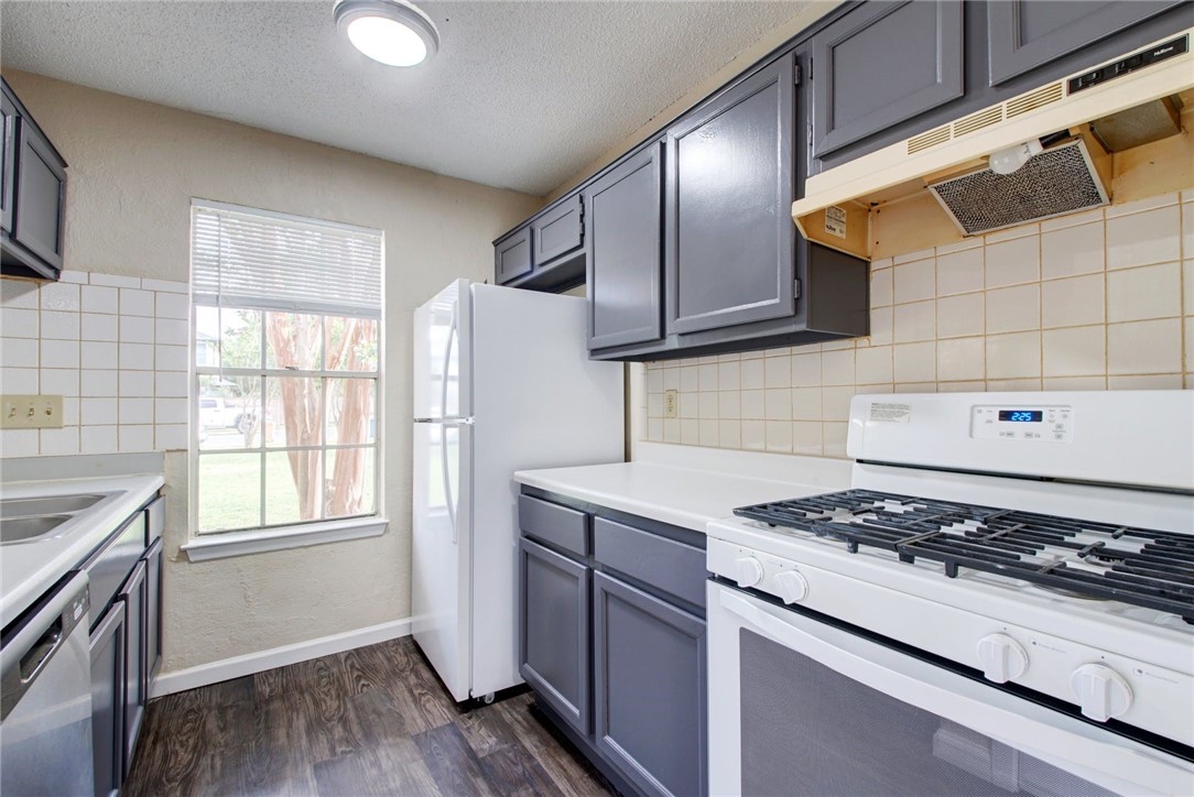 2003 Pipers Field Drive, Unit A Austin, TX 78758 - Photo 12 of 25 a kitchen with granite countertop a stove and a refrigerator