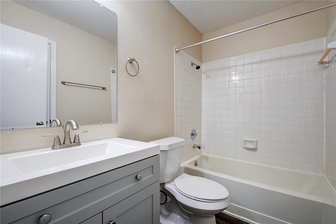 2003 Pipers Field Drive, Unit A Austin, TX 78758 - Photo 17 of 25 a bathroom with a sink a toilet and a bathtub