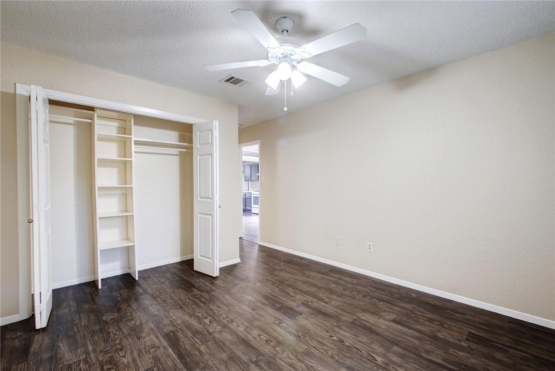 2003 Pipers Field Drive, Unit A Austin, TX 78758 - Photo 19 of 25 an empty room with wooden floor and windows