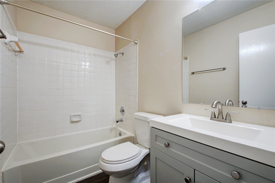 2003 Pipers Field Drive, Unit A Austin, TX 78758 - Photo 20 of 25 a bathroom with a sink a toilet and a bathtub