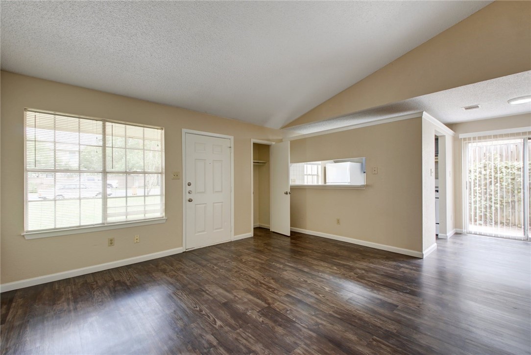 2003 Pipers Field Drive, Unit A Austin, TX 78758 - Photo 5 of 25 an empty room with wooden floor and windows
