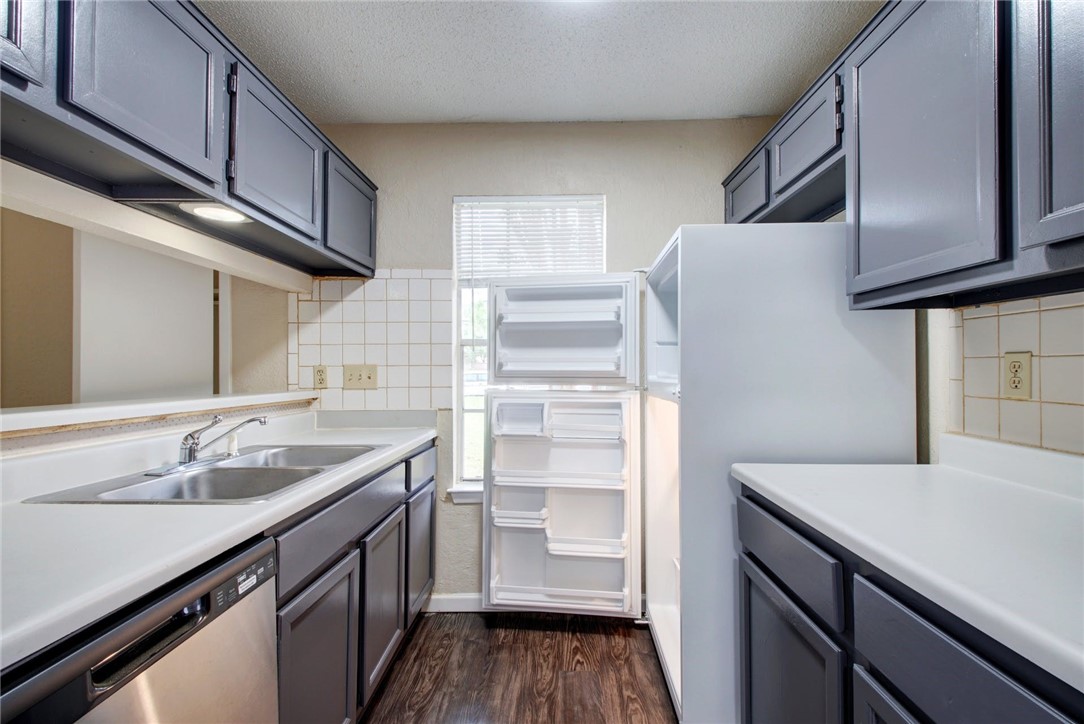 2003 Pipers Field Drive, Unit A Austin, TX 78758 - Photo 8 of 25 a kitchen with a sink cabinets and wooden floor
