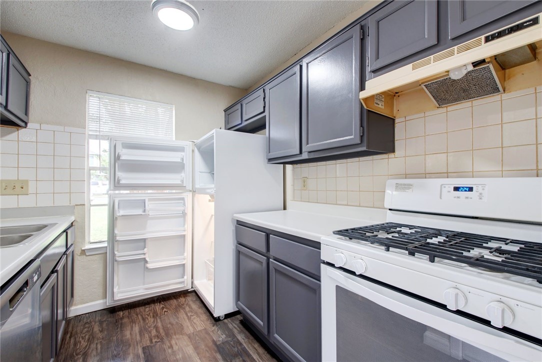 2003 Pipers Field Drive, Unit A Austin, TX 78758 - Photo 9 of 25 a kitchen with a stove and a refrigerator