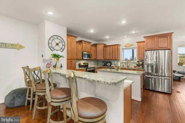 a view of a bedroom with a bed and wooden floor
