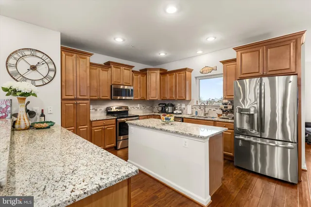 a bedroom with a bed a large window and potted plant on the dresser