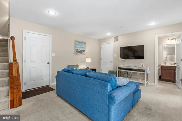 a kitchen with granite countertop a table chairs stove a sink and dishwasher