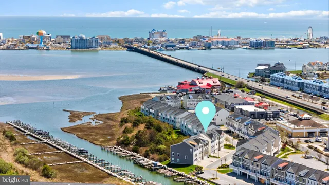 a kitchen with stainless steel appliances granite countertop a sink a stove a refrigerator cabinets and a dining table