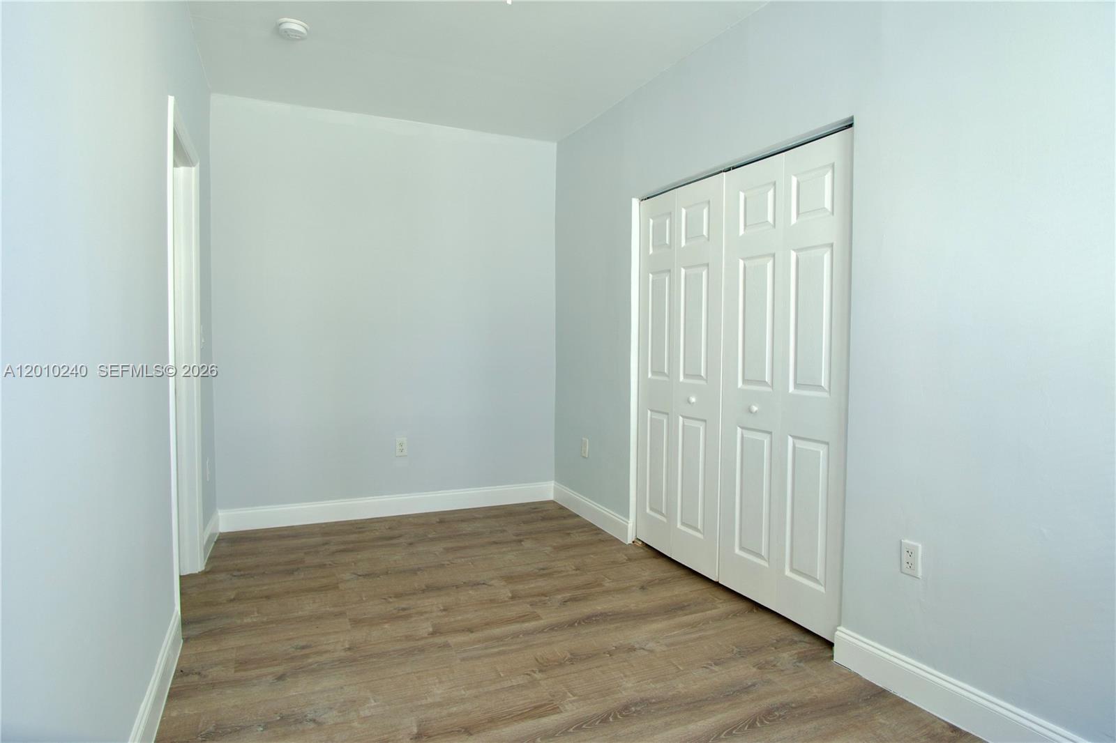 1142 Southwest 4th Street, Unit 17 Miami, FL 33130 - Photo 9 of 20 a view of an empty room with wooden floor