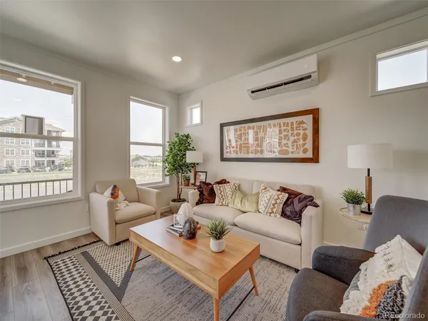 a living room with furniture and a large window