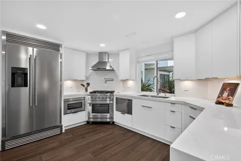 a kitchen with a sink stainless steel appliances and cabinets