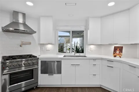 a kitchen with a stove and white cabinets