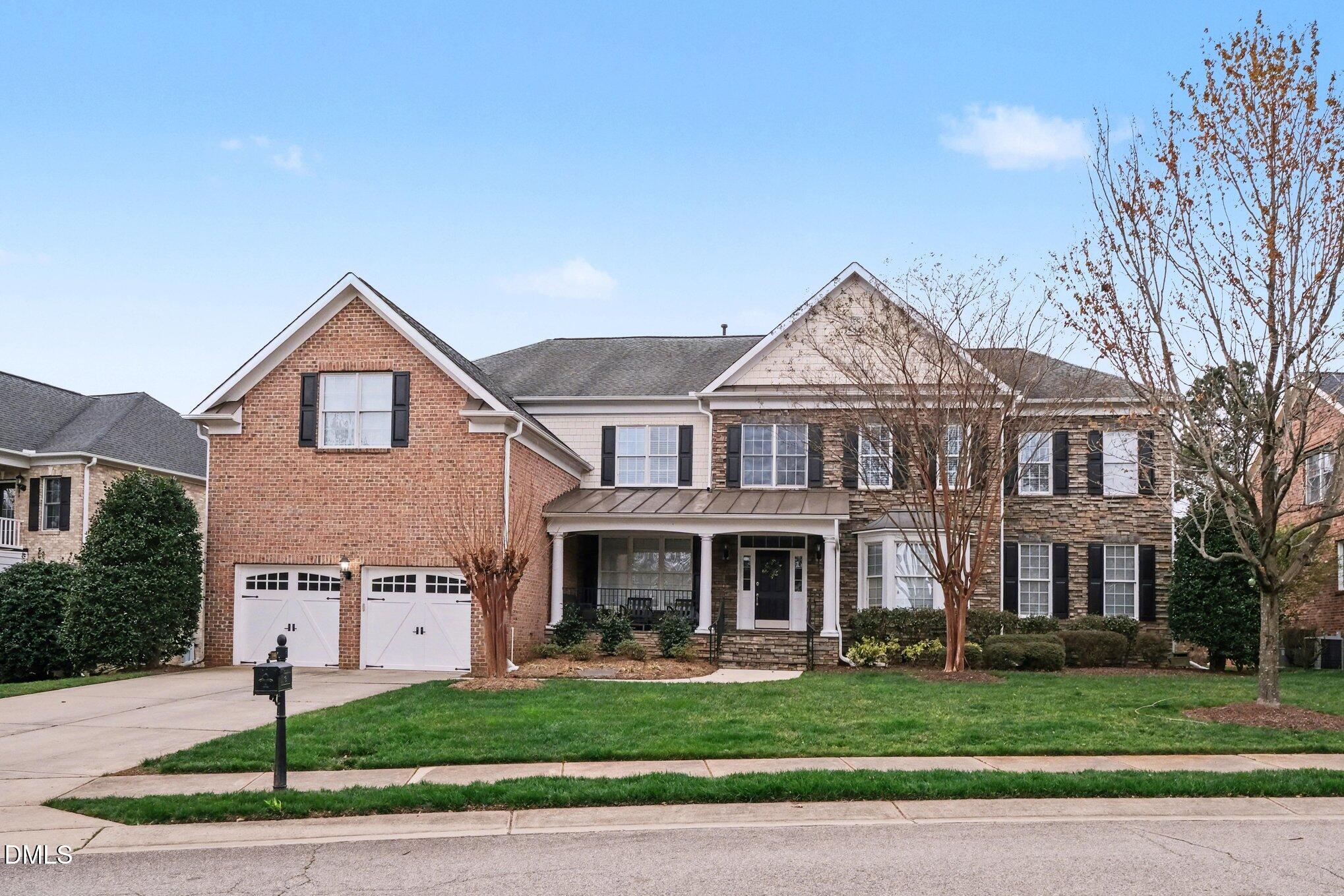 10643 Tarton Fields Circle Raleigh, NC 27617 - Photo 1 of 53 a front view of residential houses with yard and green space