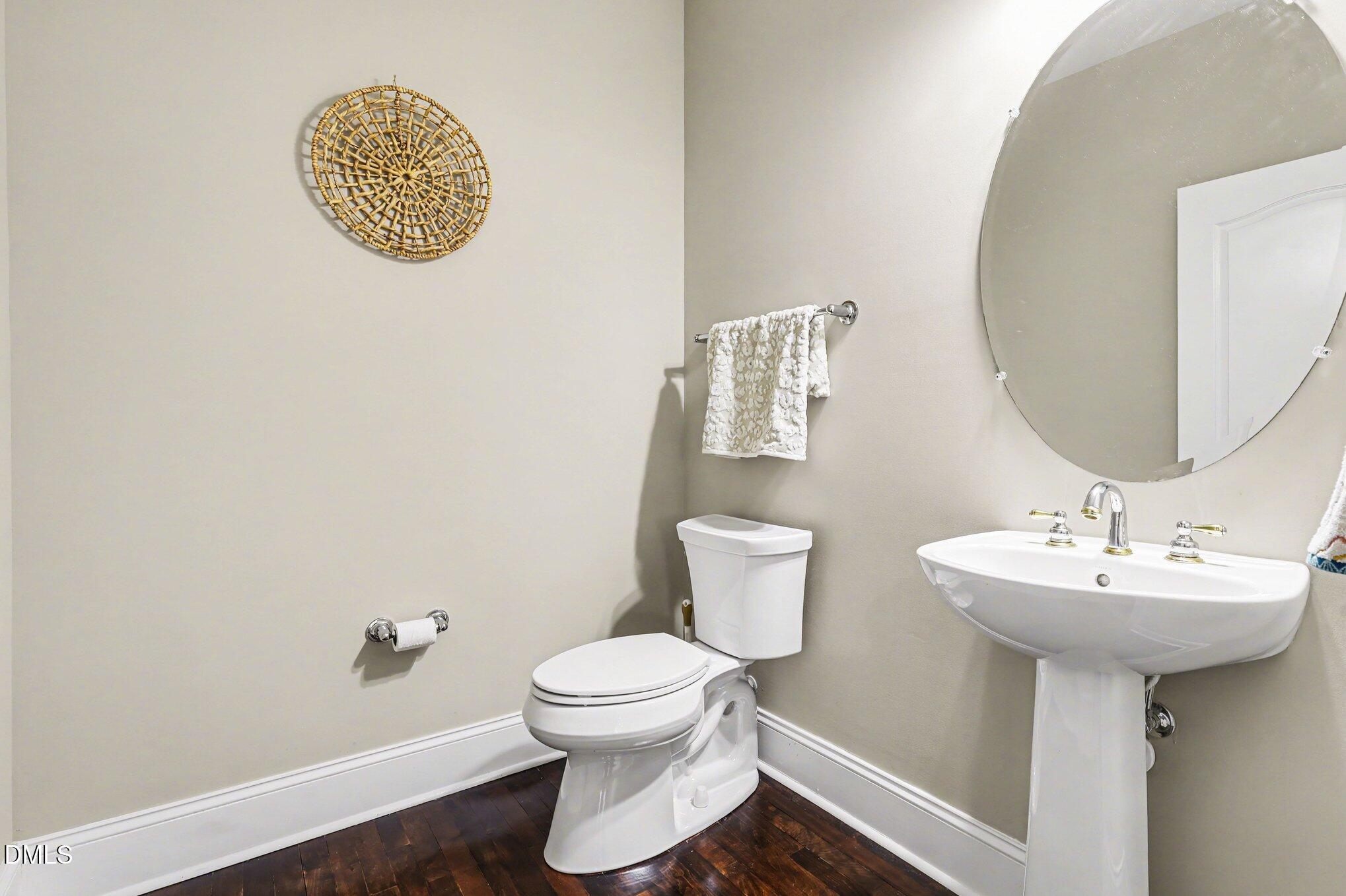 10643 Tarton Fields Circle Raleigh, NC 27617 - Photo 19 of 53 a bathroom with a sink toilet and a mirror
