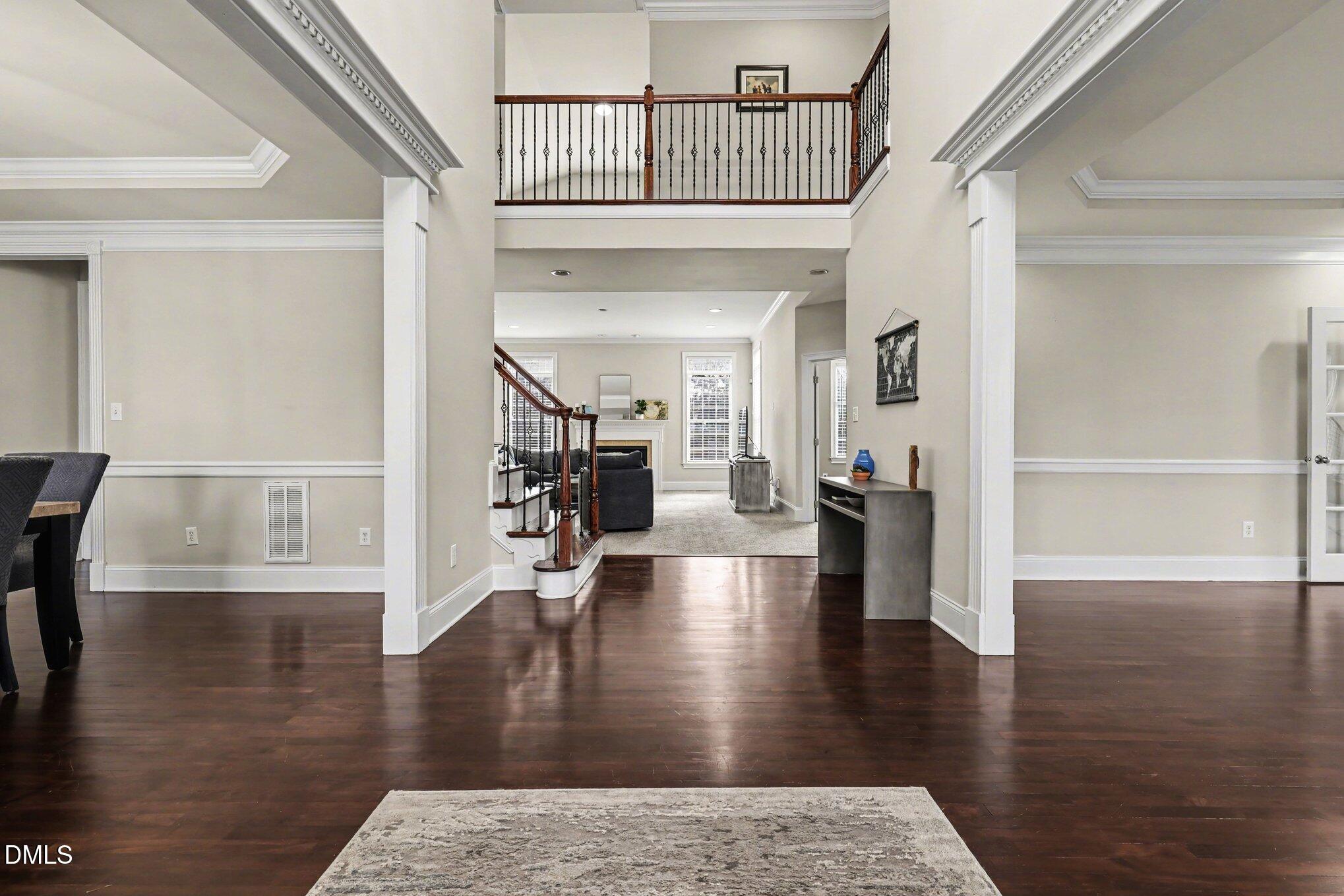 10643 Tarton Fields Circle Raleigh, NC 27617 - Photo 24 of 53 a view of entryway and hall with wooden floor