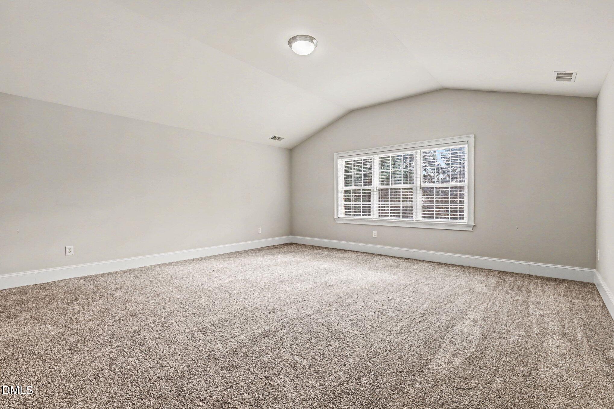 10643 Tarton Fields Circle Raleigh, NC 27617 - Photo 40 of 53 an empty room with a empty space and windows