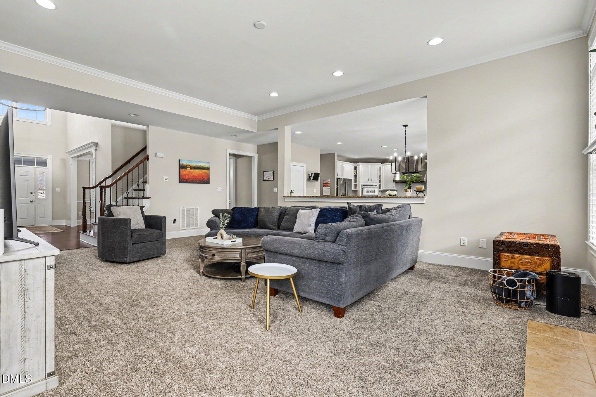 10643 Tarton Fields Circle Raleigh, NC 27617 - Photo 6 of 53 a living room with furniture and a flat screen tv