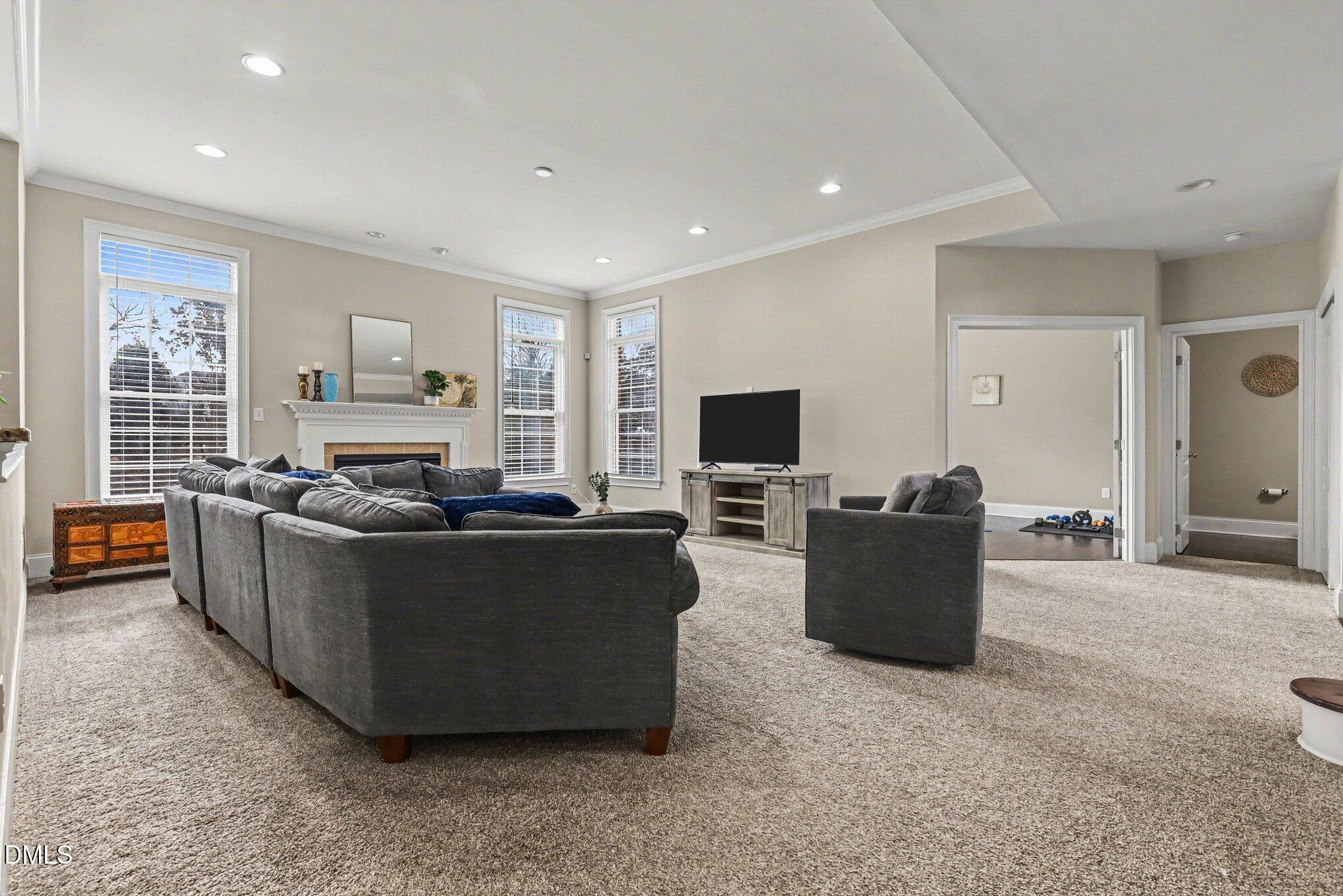10643 Tarton Fields Circle Raleigh, NC 27617 - Photo 7 of 53 a living room with furniture and a flat screen tv