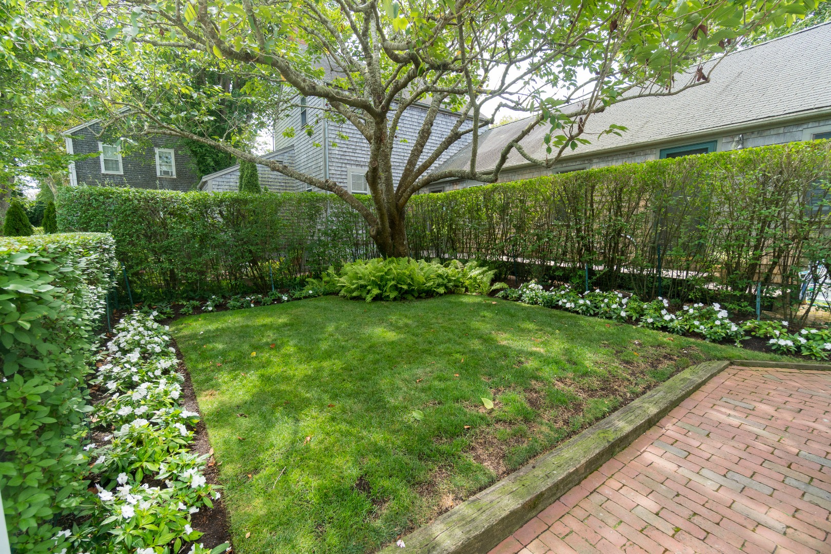 37 Union Street Nantucket, MA 02554 - Photo 4 of 25 a view of a backyard with potted plants and large trees
