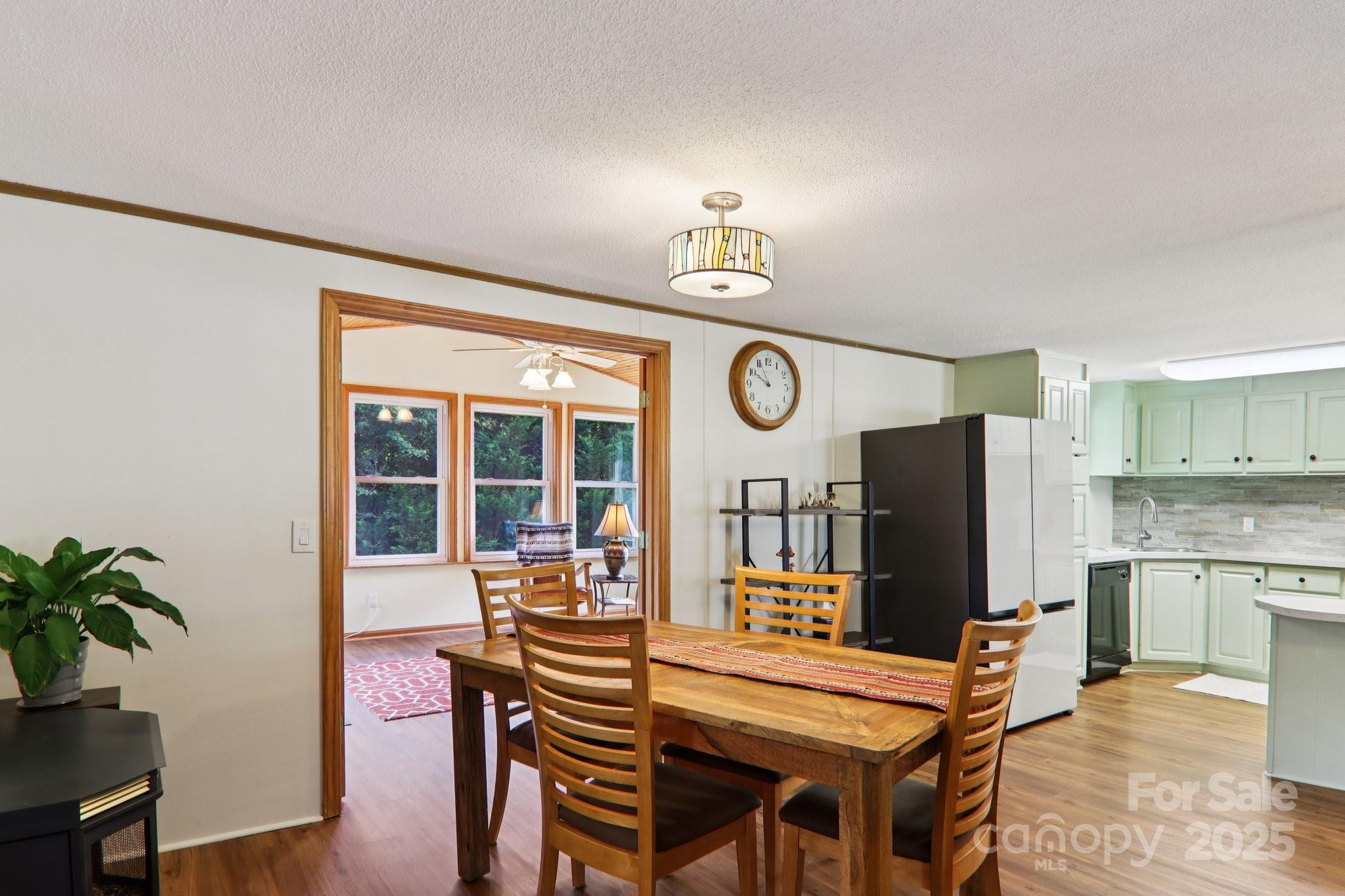 226 Cranbrook Circle Hendersonville, NC 28792 - Photo 15 of 47 a view of a dining room with furniture and a window