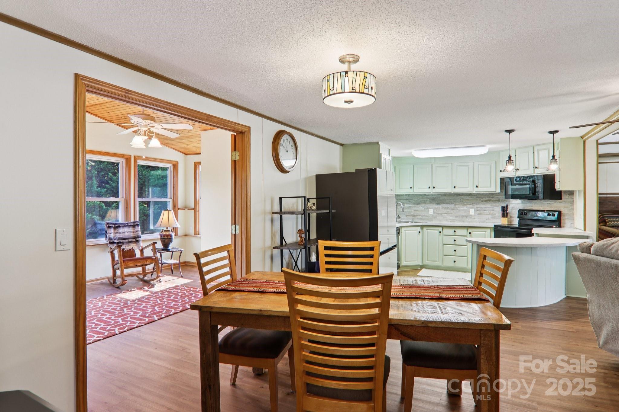 226 Cranbrook Circle Hendersonville, NC 28792 - Photo 16 of 47 a dining room with furniture a chandelier and wooden floor
