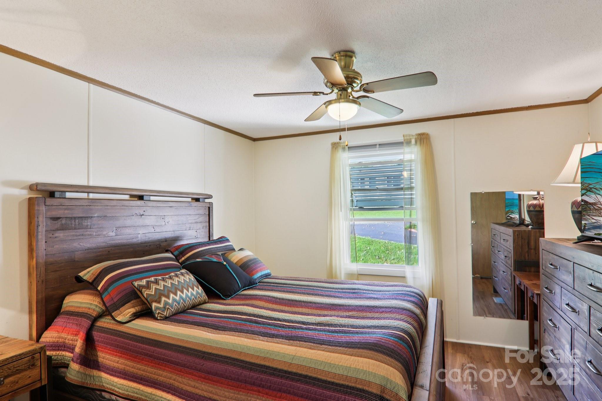 226 Cranbrook Circle Hendersonville, NC 28792 - Photo 19 of 47 a bedroom with a bed and wooden floor