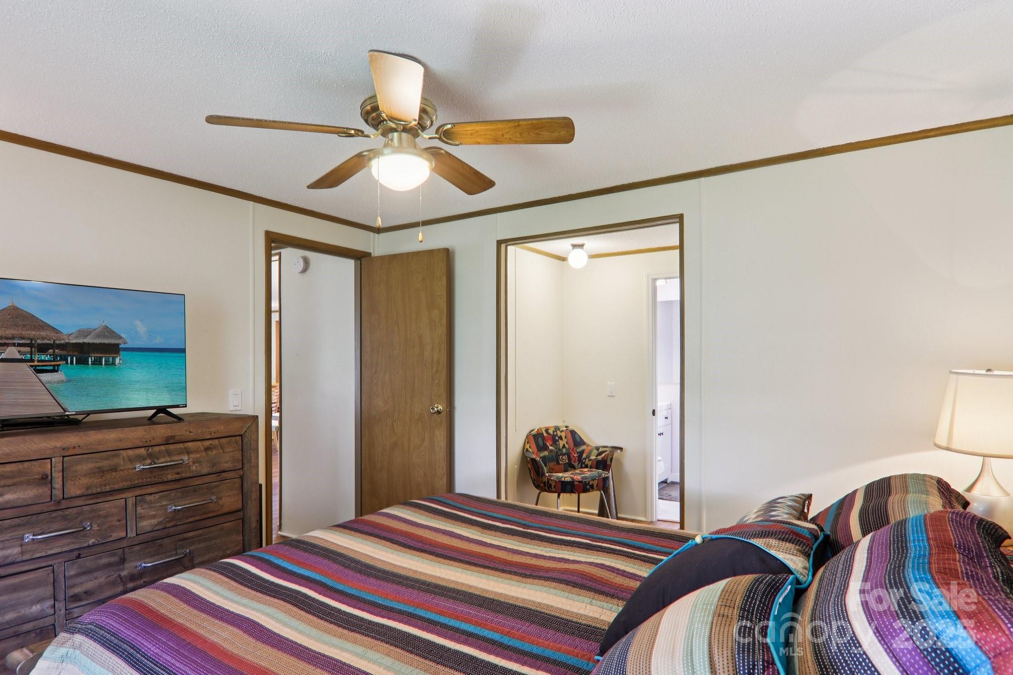 226 Cranbrook Circle Hendersonville, NC 28792 - Photo 20 of 47 a bedroom with a bed and a chandelier