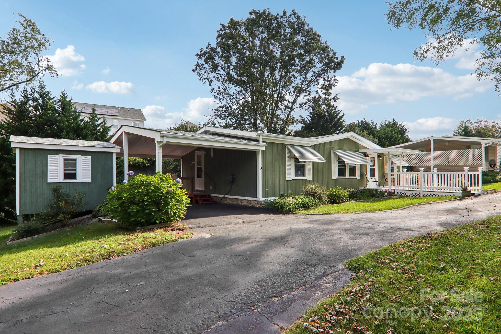 226 Cranbrook Circle Hendersonville, NC 28792 - Photo 3 of 47 a front view of a house with a yard and potted plants