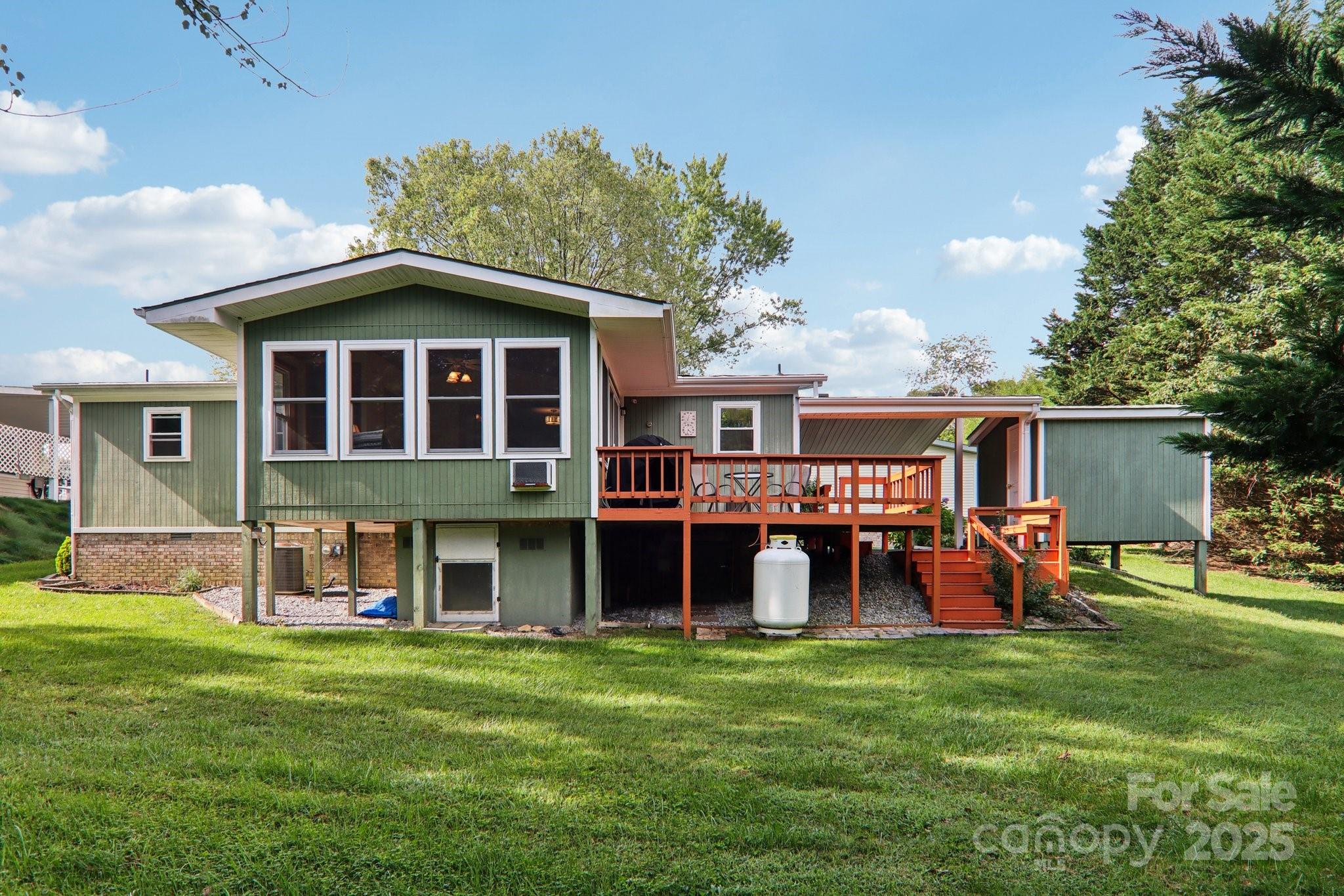 226 Cranbrook Circle Hendersonville, NC 28792 - Photo 38 of 47 a front view of a house with garden