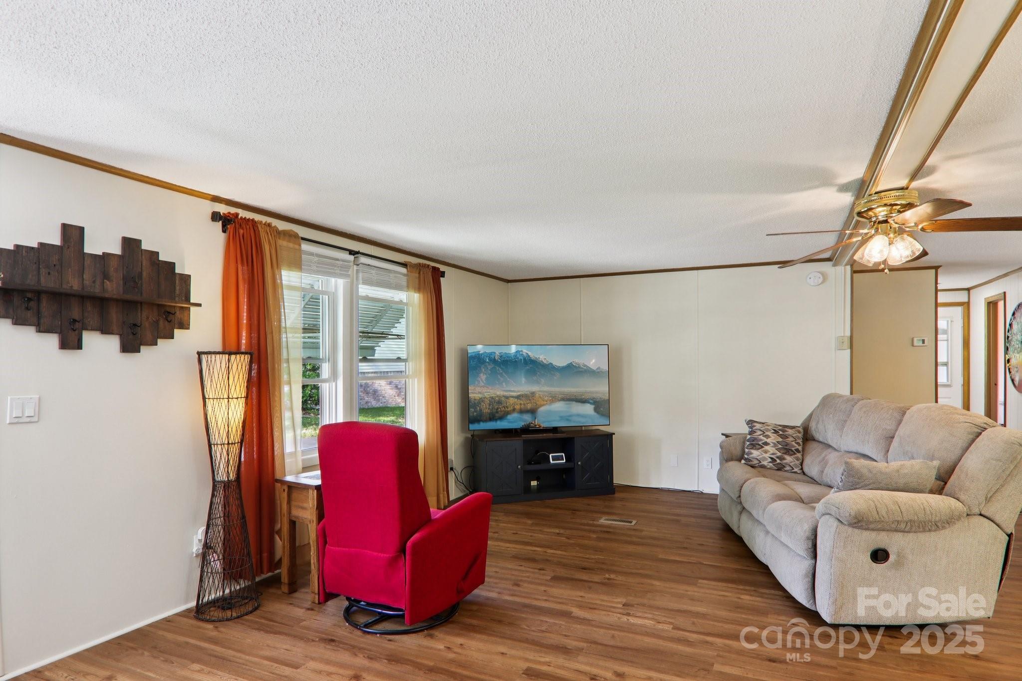 226 Cranbrook Circle Hendersonville, NC 28792 - Photo 9 of 47 a living room with furniture a fireplace and a flat screen tv