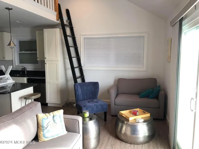 a kitchen with a sink a microwave a refrigerator and cabinets