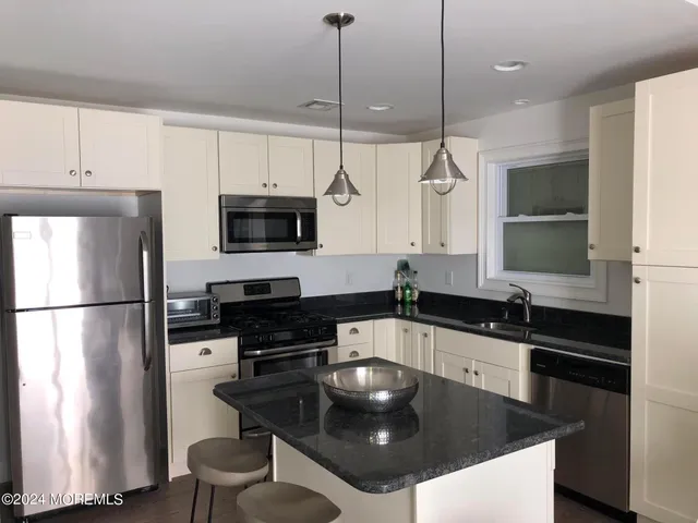 a bathroom with a shower a toilet and a sink