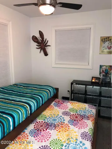 a bed sitting in a bedroom next to a lamp